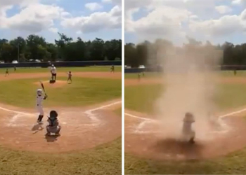 Niño queda en el centro de un remolino de arena durante partido de béisbol